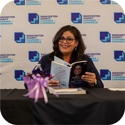 Lucy Escobar with her book at the Washington Chamber of Commerce