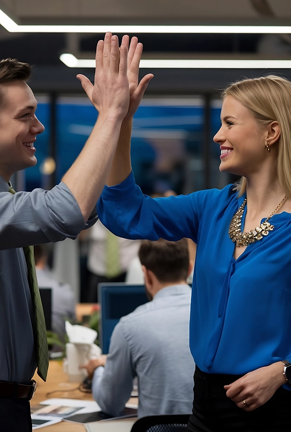 Two people high fiving each other